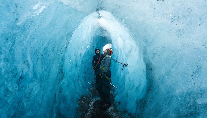 Happy couple in blue ice tunnel