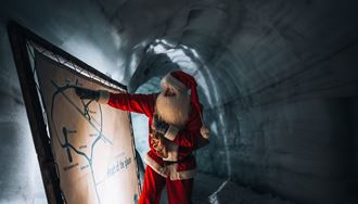 Yule Lad Looking And Pointing To The Map Of Ice Tunnel On Langjokull in iceland
