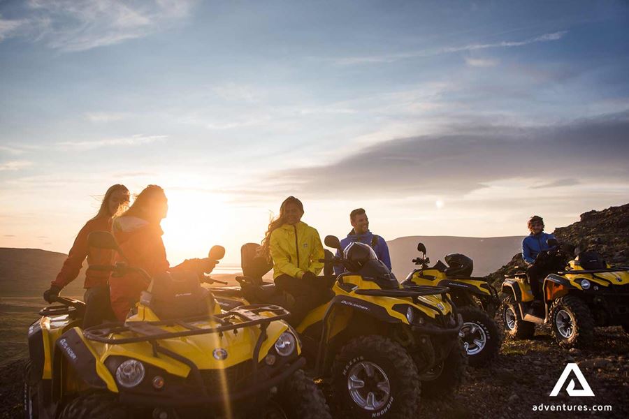 friends atv riding at sunset