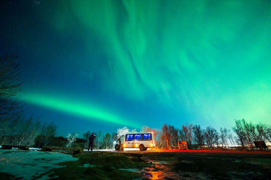 4X4 Sprinter Standing On The Road Under Northern Lights