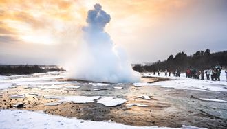Geysir Geyser And Tourists In Snow in iceland