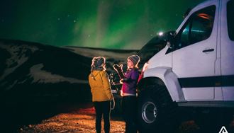 talking about northern lights with a friend in iceland