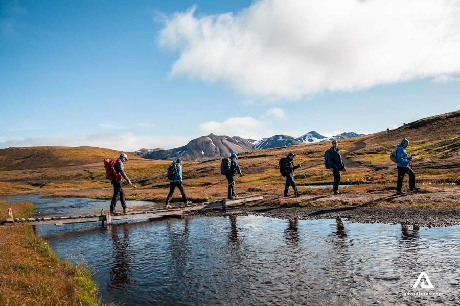 Hikers crossing river in Landmannalaugar