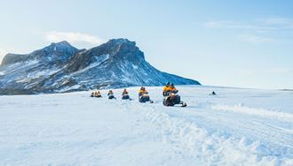Group Of Snowmobiles On A Tour In Iceland