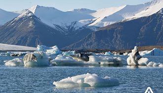 sunny day mountain range view at jokulsarlon in south iceland