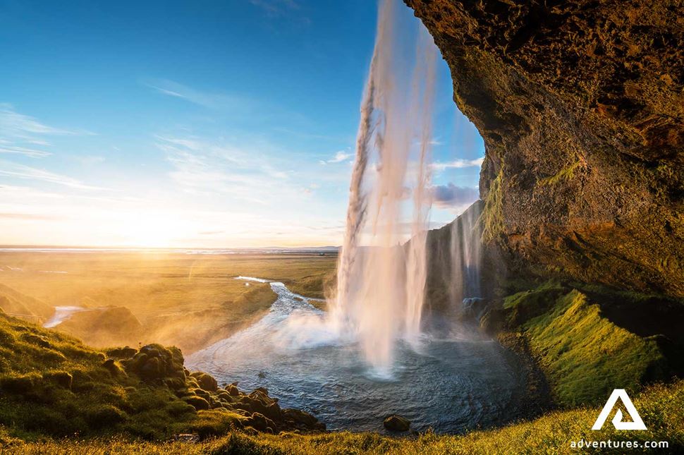 sunset at seljalandsfoss waterfall in iceland south coast