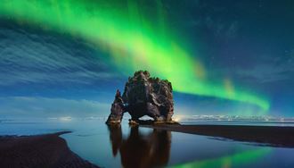 northern lights above hvitserkur rock formation