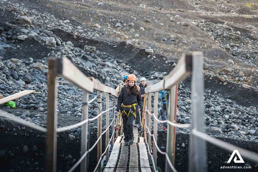 explorers walking on bridge