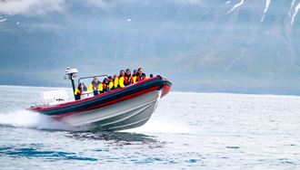 Fast rib boat going through water with a group