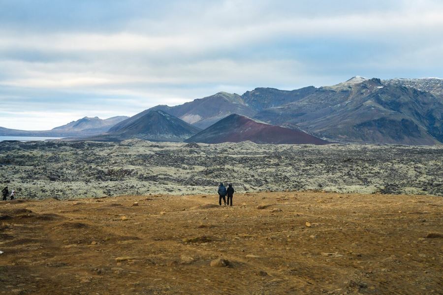 A Pair Of People Standing And Gazing At Snaefellsnes Peninsula in iceland