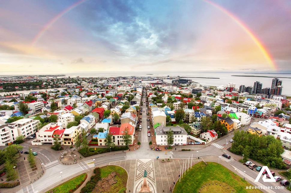 rainbow above reykjavik city at sunset