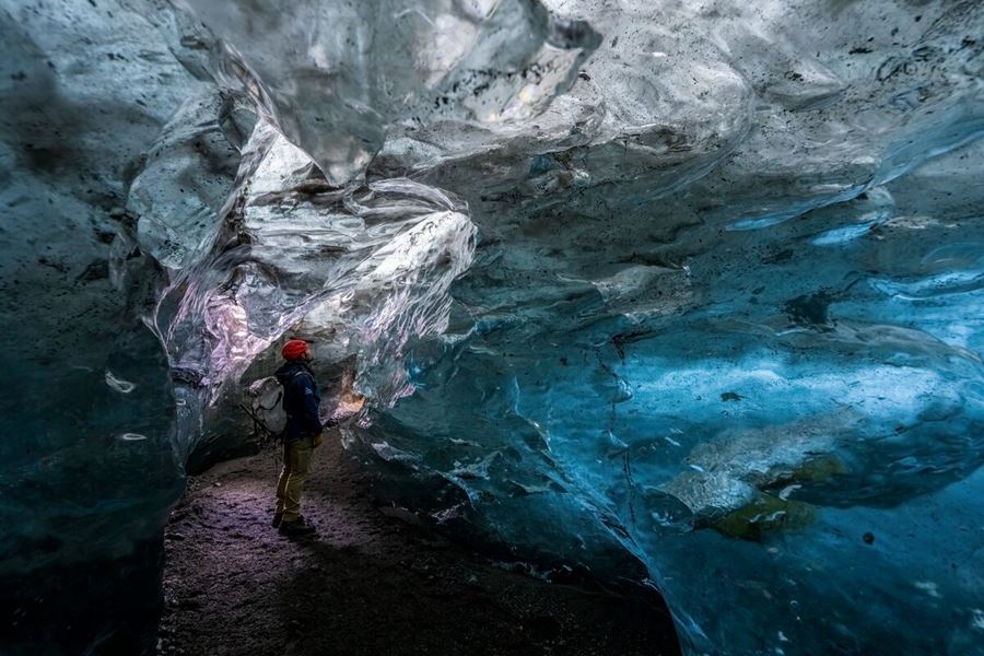 Tourist exploring inside Crystal ice cave in Vatnajokull 2025.