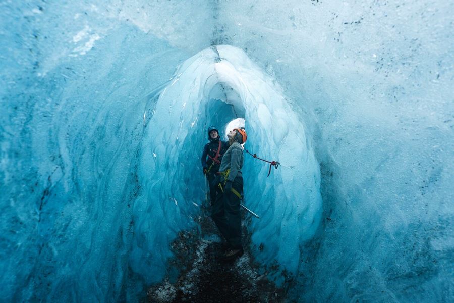 Happy couple in blue ice tunnel