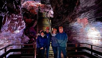 happy friends posing for a picture in raufarholshellir