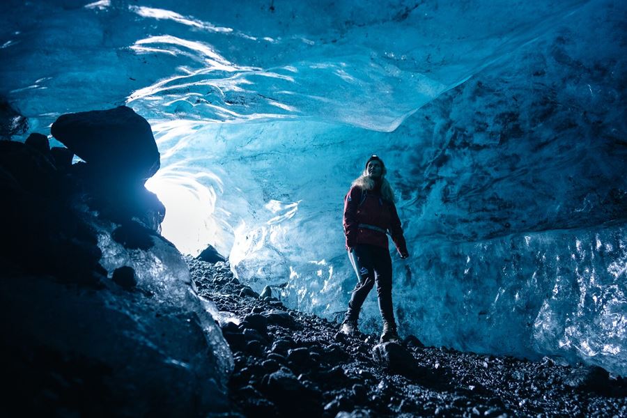 Woman Walking In Blue Ice Cave In Iceland
