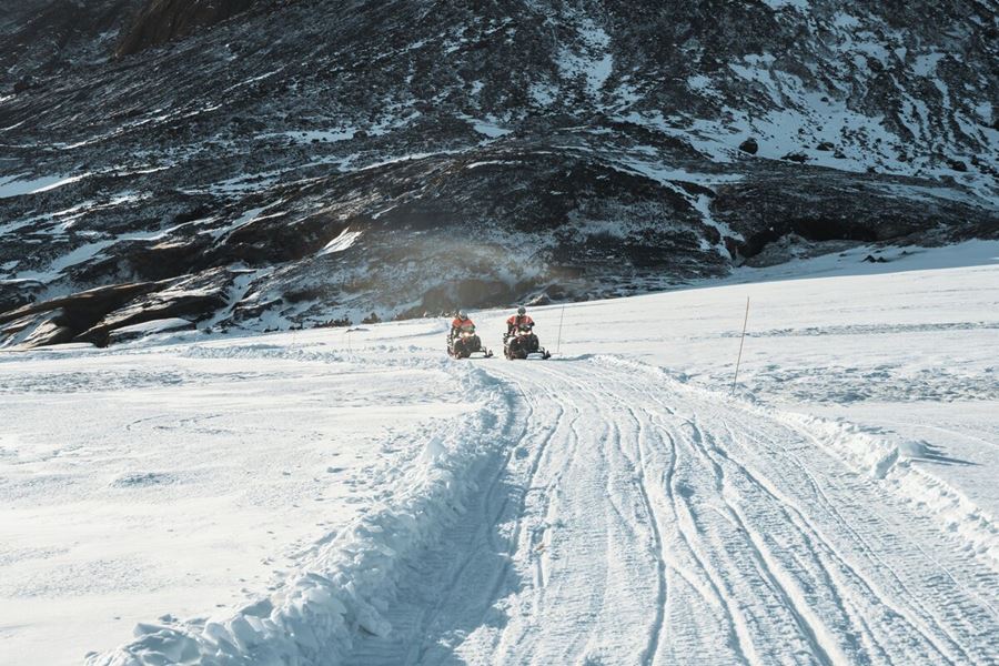 Snowmobiles Driving On Snow On Langjokull Glacier
