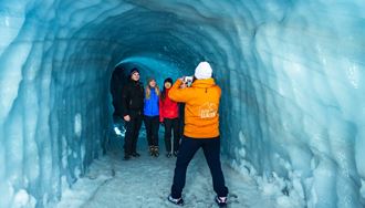 Small group tour posing for photos inside Langjokull ice tunnel 