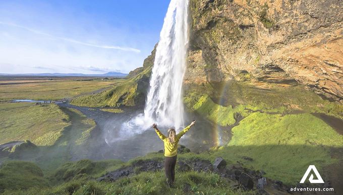 woman near seljalandsfoss waterfall in summer