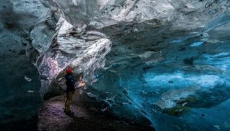 Tourist exploring inside Crystal ice cave in Vatnajokull 2025.