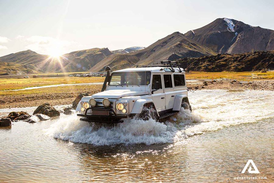super jeep crossing a shallow river