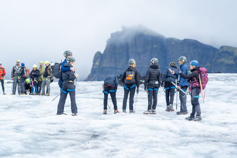 Two groups of people on Icelandic glacier