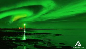 northern lights above grotta lighthouse in reykjavik