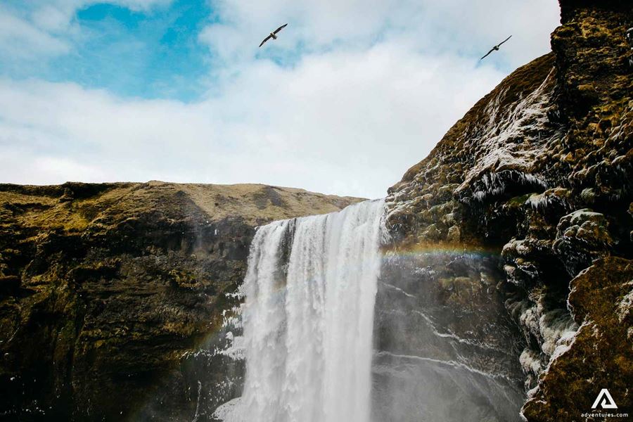 rainbow over skogafoss waterfall