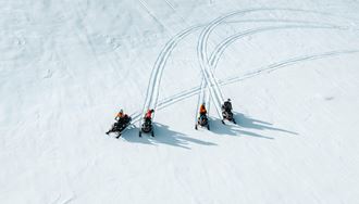 Four Snowmobiles Stopped On The langjokull Glacier