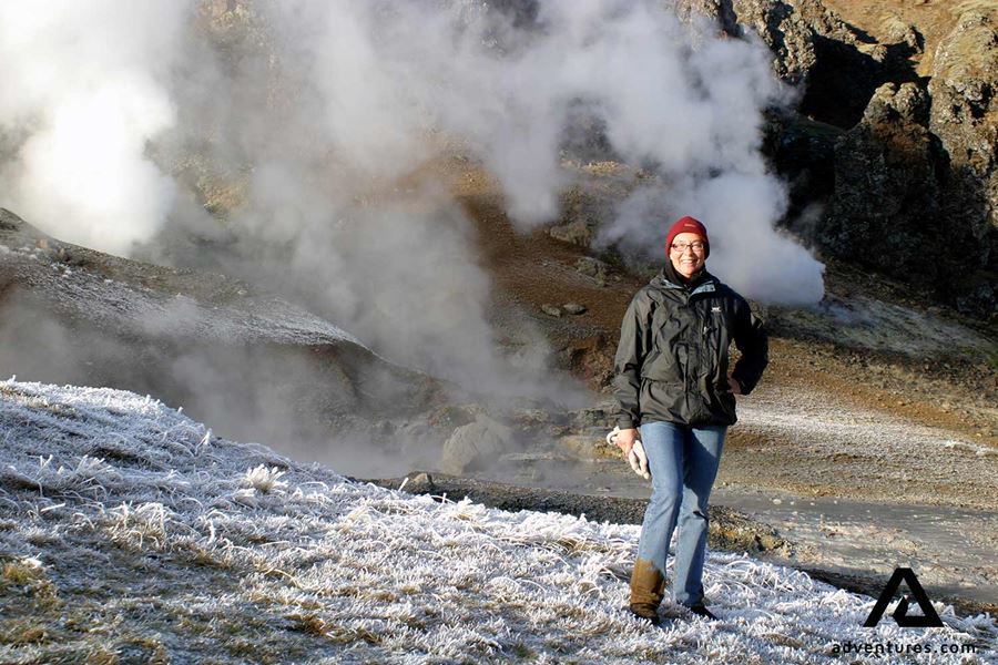 woman posing near steaming hot springs