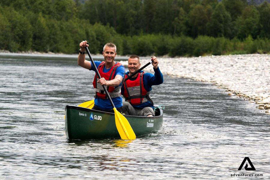 two men canoeing in river