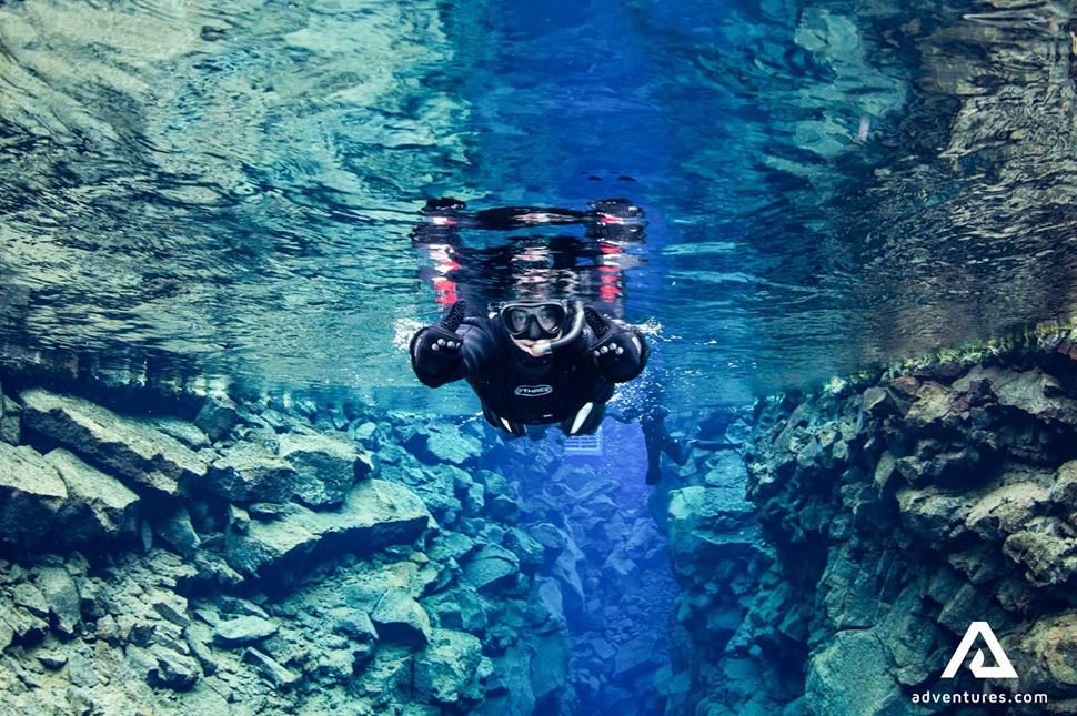 showing thumbs up while snorkeling in silfra