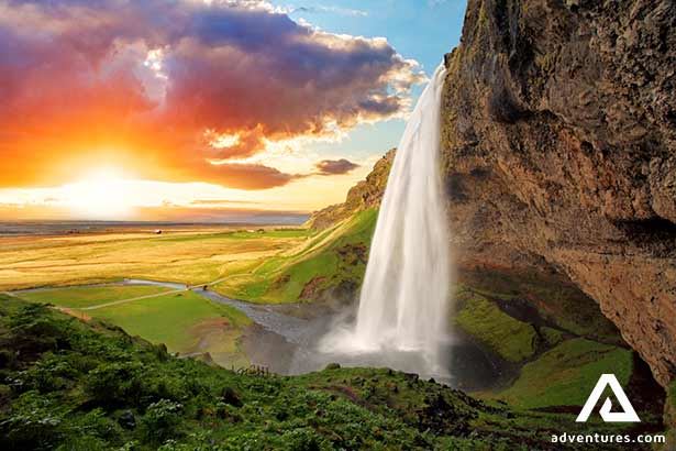 seljalandsfoss waterfall at bright sunset in summer