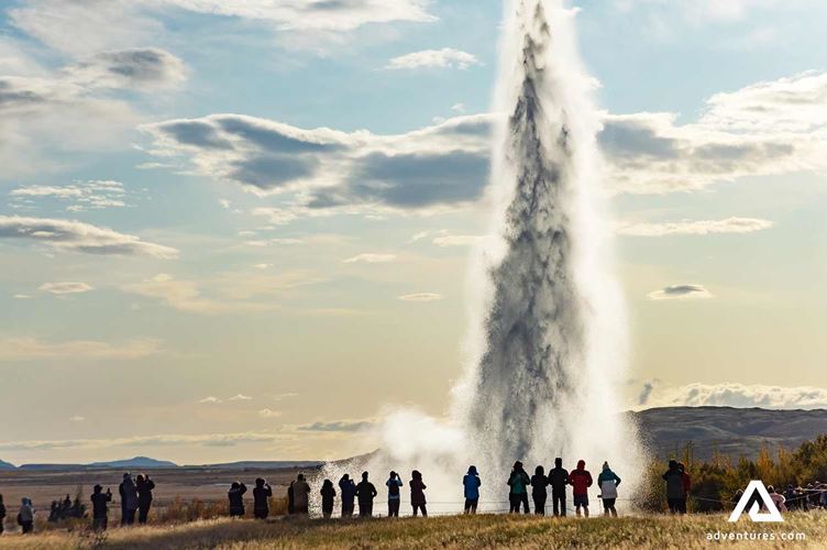 People Standing Near Geysir hot spring