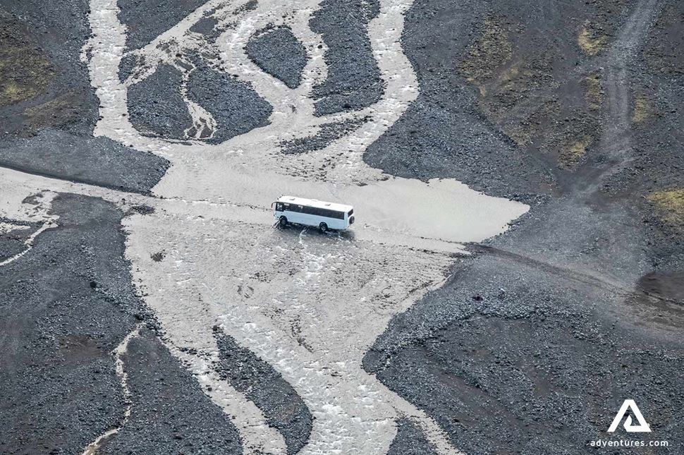 4x4 bus crossing a river in iceland