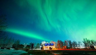 4X4 Sprinter Standing On The Road Under Northern Lights