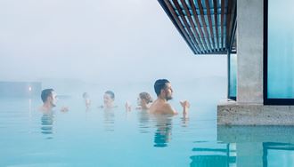 people bathing near a bar at blue lagoon in iceland