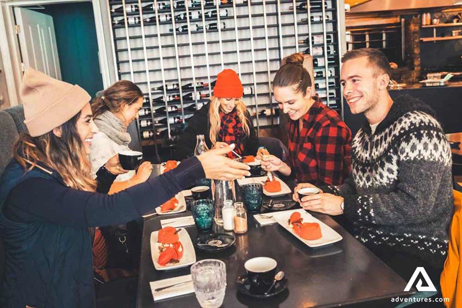happy group of friends tasting food