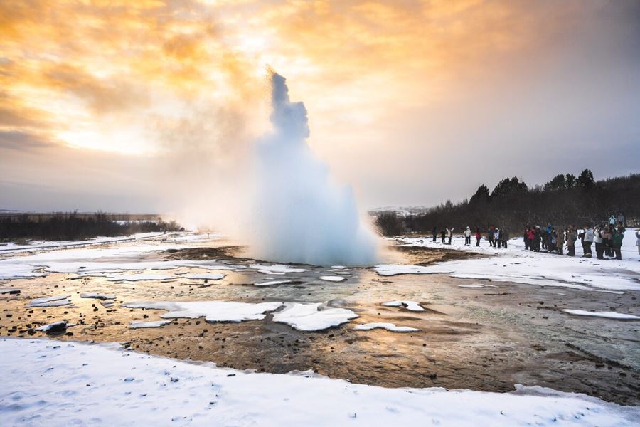 Geysir Geyser Erupting Surrounded By Snow in Iceland