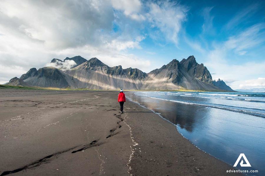woman in red walking in stokksnes