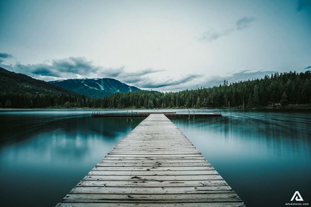 wooden bridge on a lake in canada